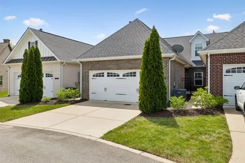 a view of a house with a yard and plants