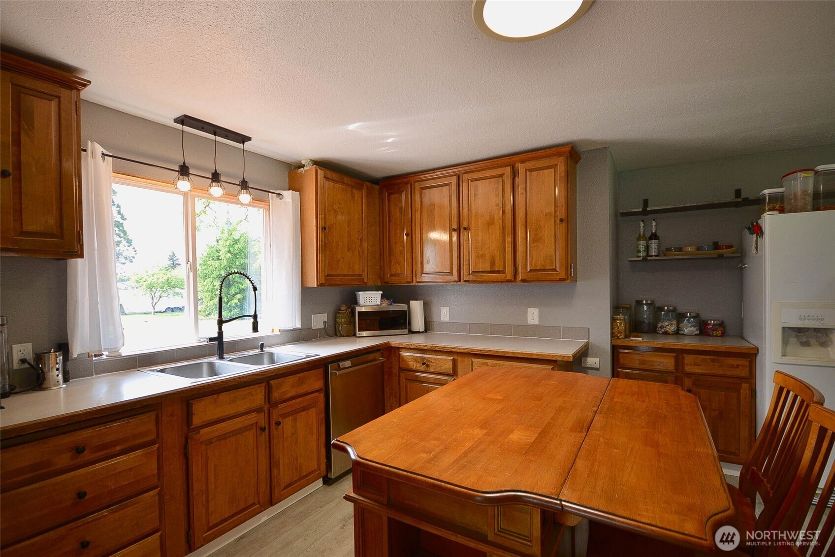 20005 Carper Road Southwest Rochester, WA 98579 - Photo 21 of 35 a kitchen with a sink and cabinets