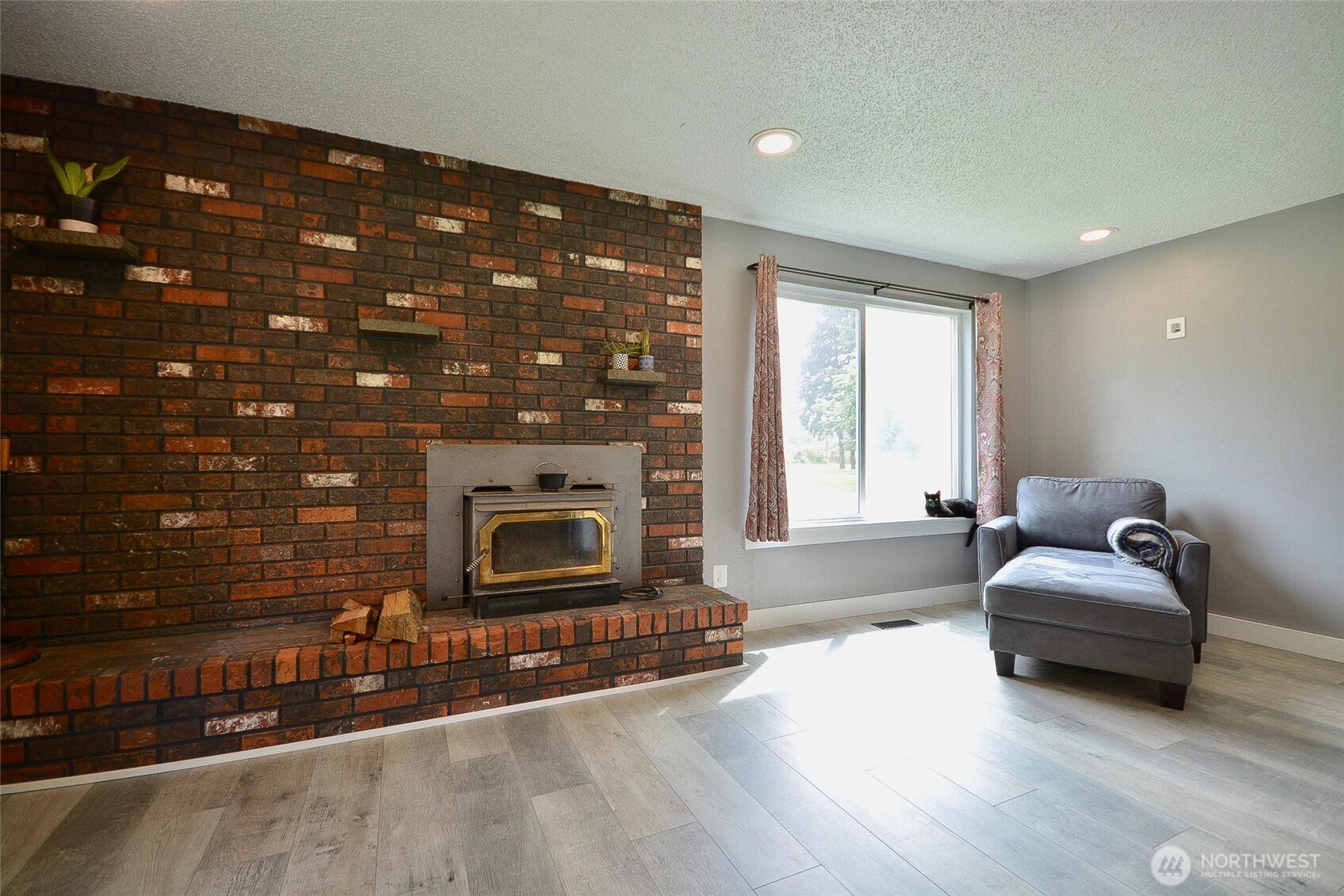 20005 Carper Road Southwest Rochester, WA 98579 - Photo 24 of 35 a living room with furniture and a fireplace