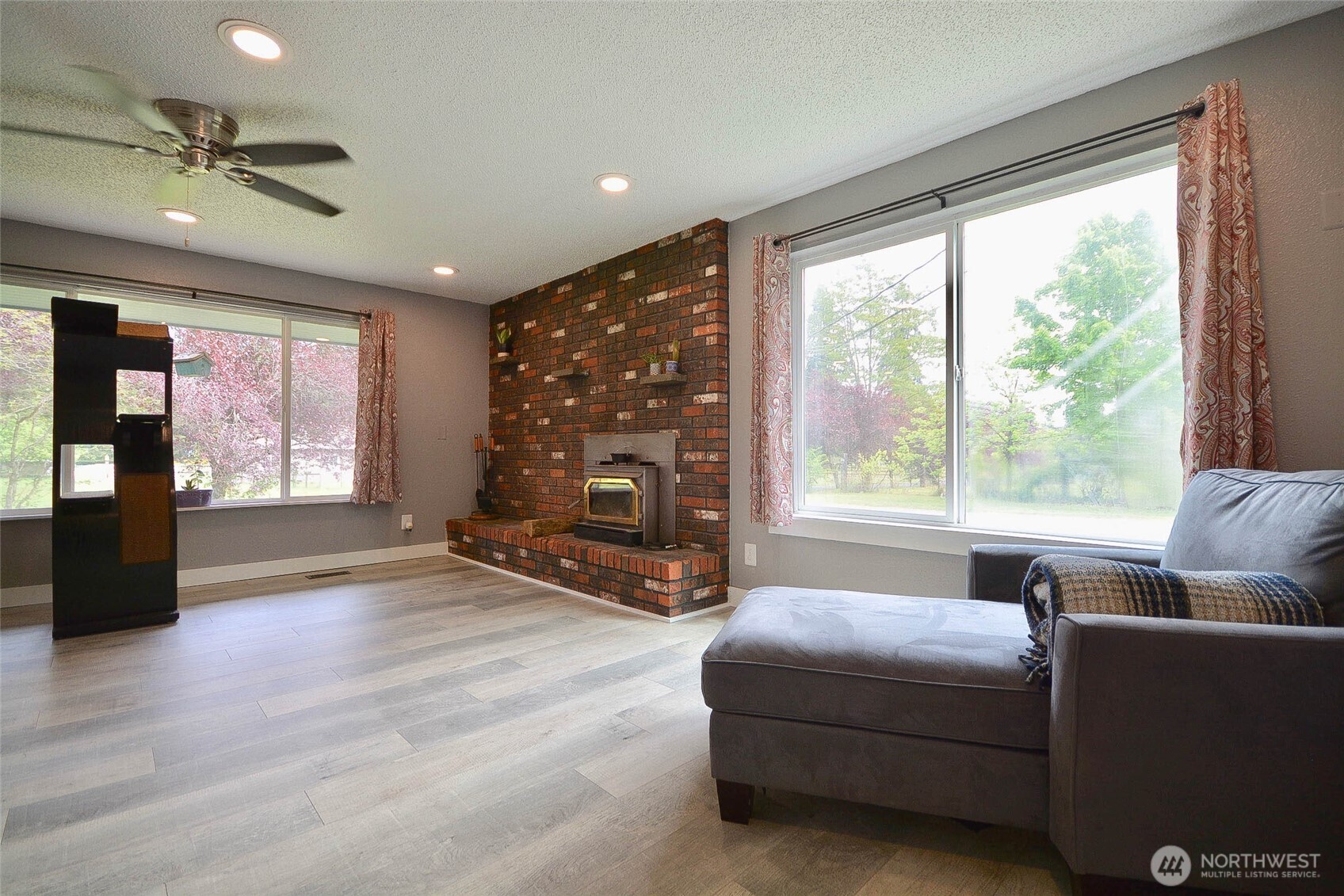 20005 Carper Road Southwest Rochester, WA 98579 - Photo 25 of 35 a living room with furniture and a fireplace