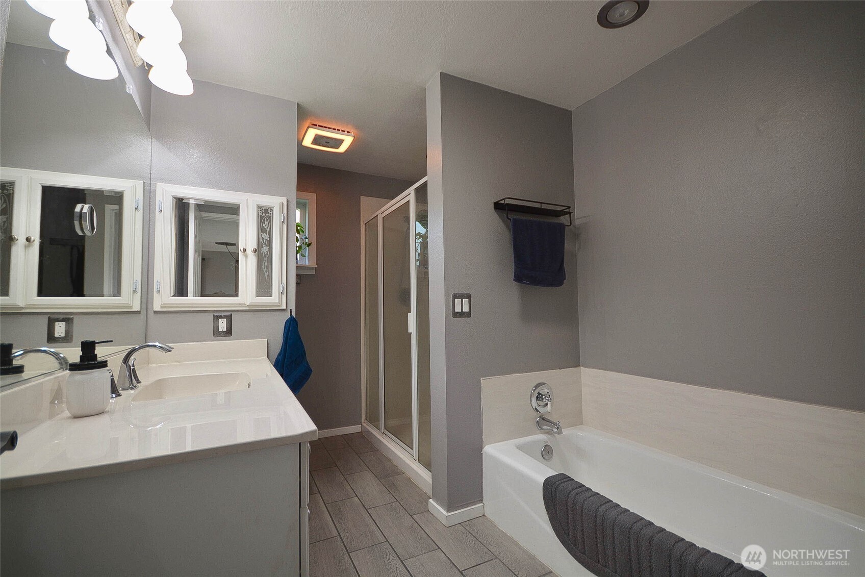20005 Carper Road Southwest Rochester, WA 98579 - Photo 28 of 35 a bathroom with a bathtub a sink and a mirror