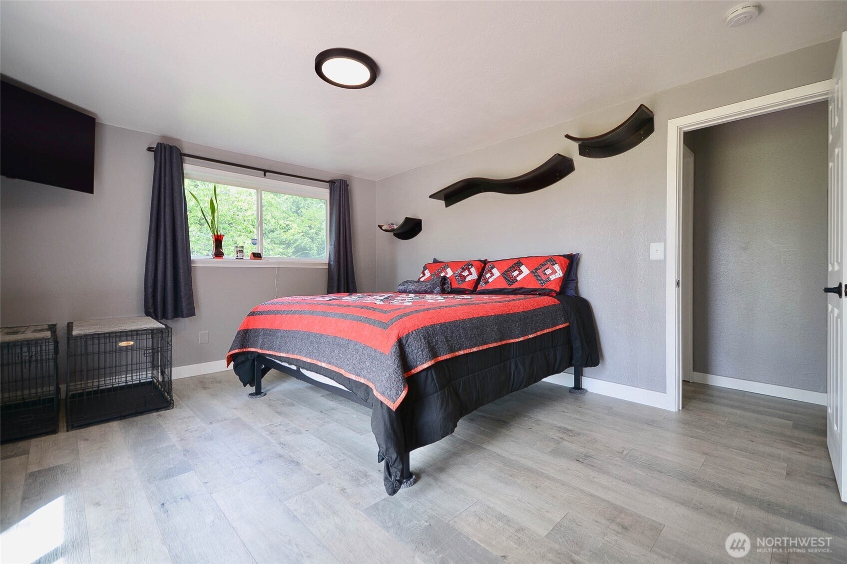 20005 Carper Road Southwest Rochester, WA 98579 - Photo 29 of 35 a bedroom with a bed and a flat tv screen on the dresser