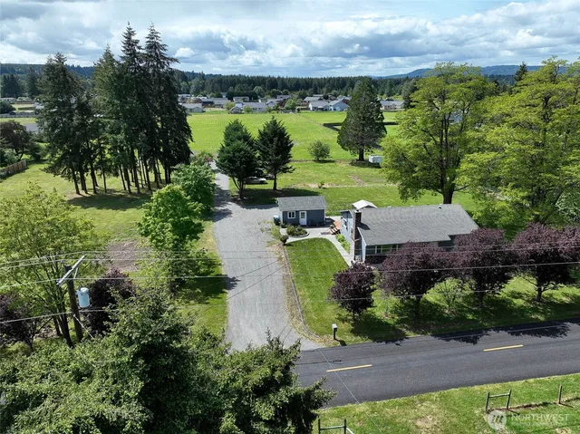 an aerial view of a house with a yard