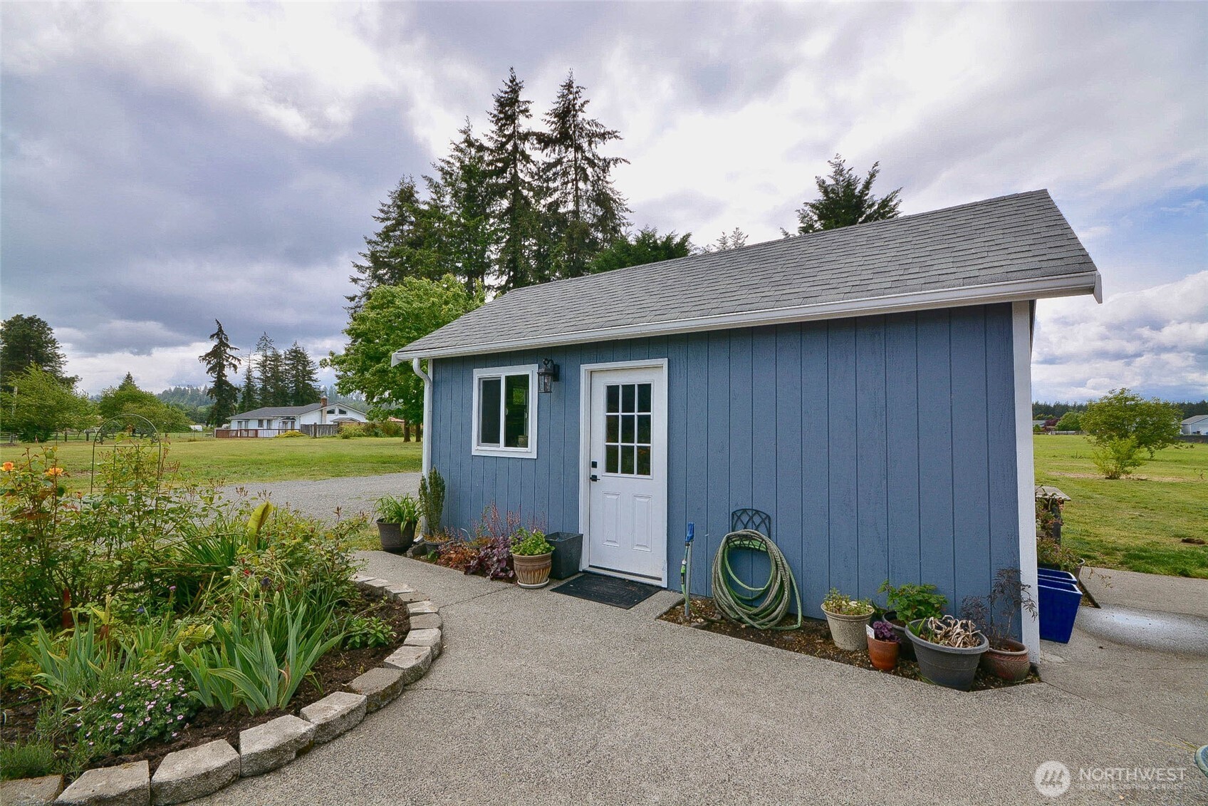 20005 Carper Road Southwest Rochester, WA 98579 - Photo 32 of 35 a backyard of a house with plants and lake view