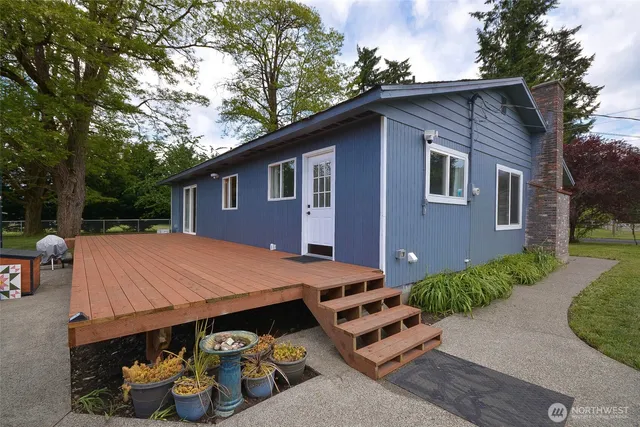 a view of a house with a patio and a yard