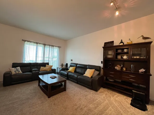a living room with furniture a rug and a window