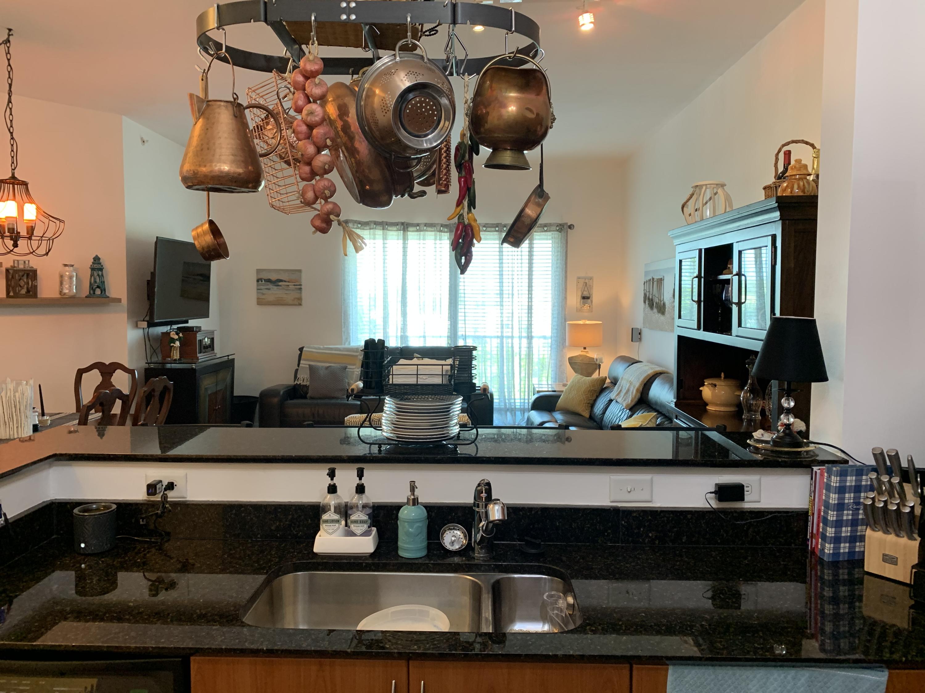 802 West Windward Way, Unit PH15 Lantana, FL 33462 - Photo 22 of 34 a kitchen with stainless steel appliances granite countertop a sink and cabinets