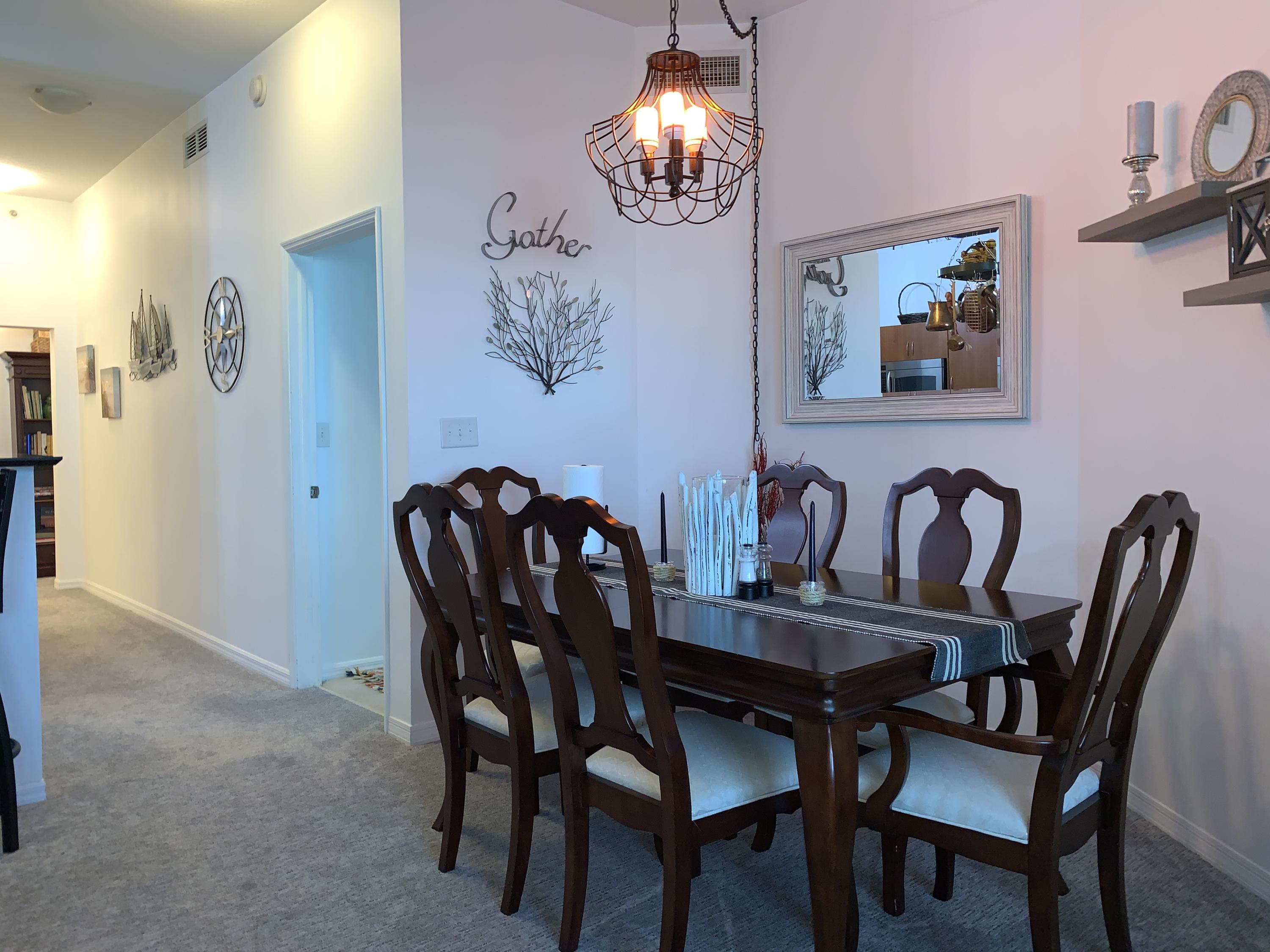 802 West Windward Way, Unit PH15 Lantana, FL 33462 - Photo 24 of 34 a view of a dining room with furniture and chandelier