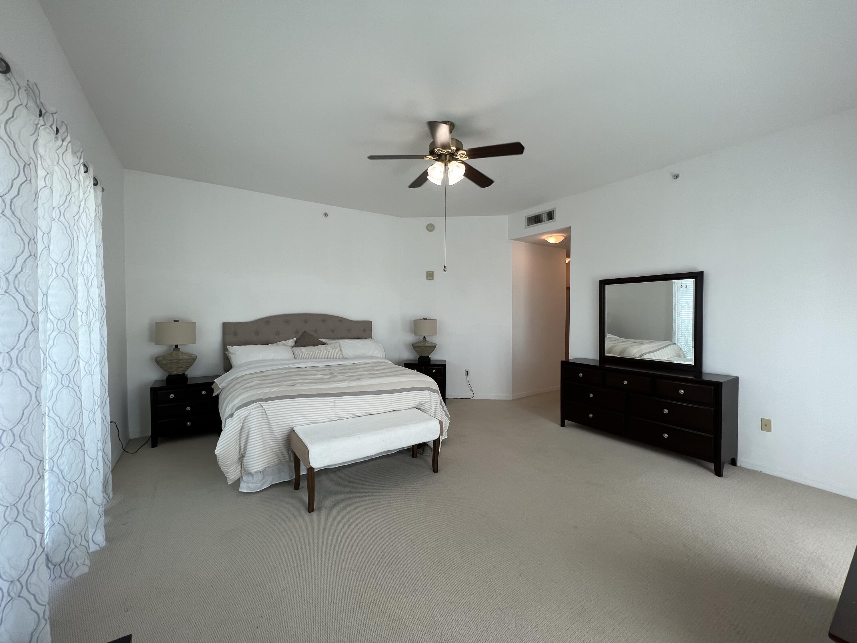 802 West Windward Way, Unit PH15 Lantana, FL 33462 - Photo 26 of 34 a bedroom with a bed and a dresser