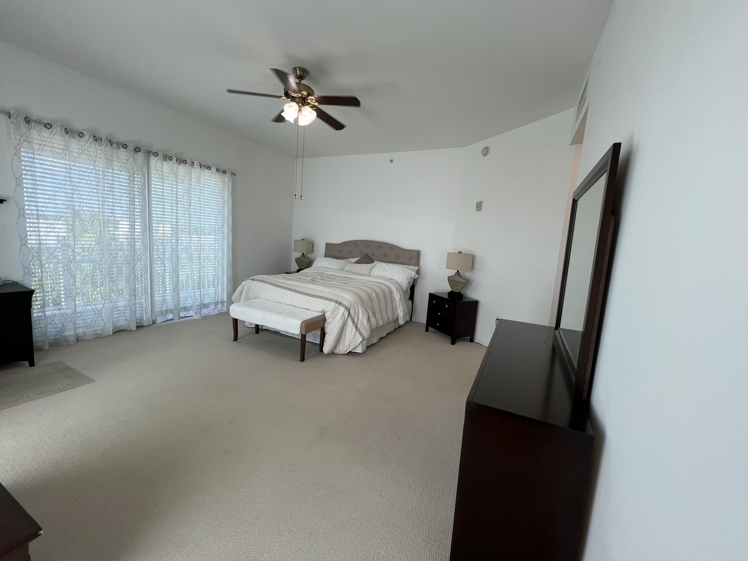 802 West Windward Way, Unit PH15 Lantana, FL 33462 - Photo 27 of 34 a bed room with a bed window and a mirror