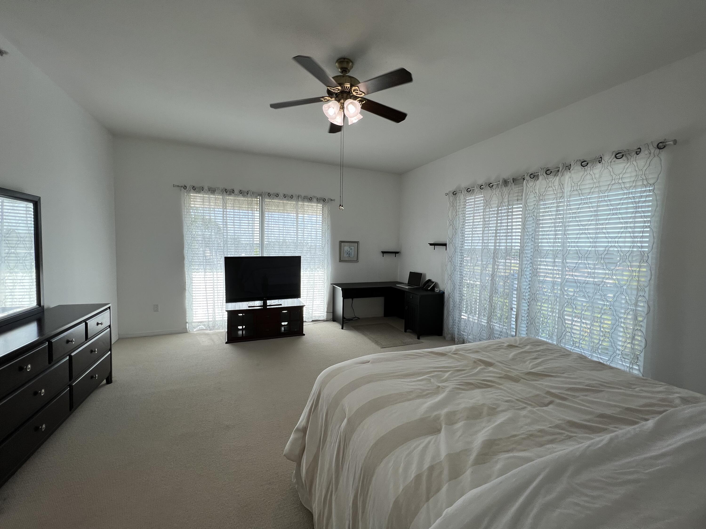802 West Windward Way, Unit PH15 Lantana, FL 33462 - Photo 28 of 34 a bed room with a bed and a television