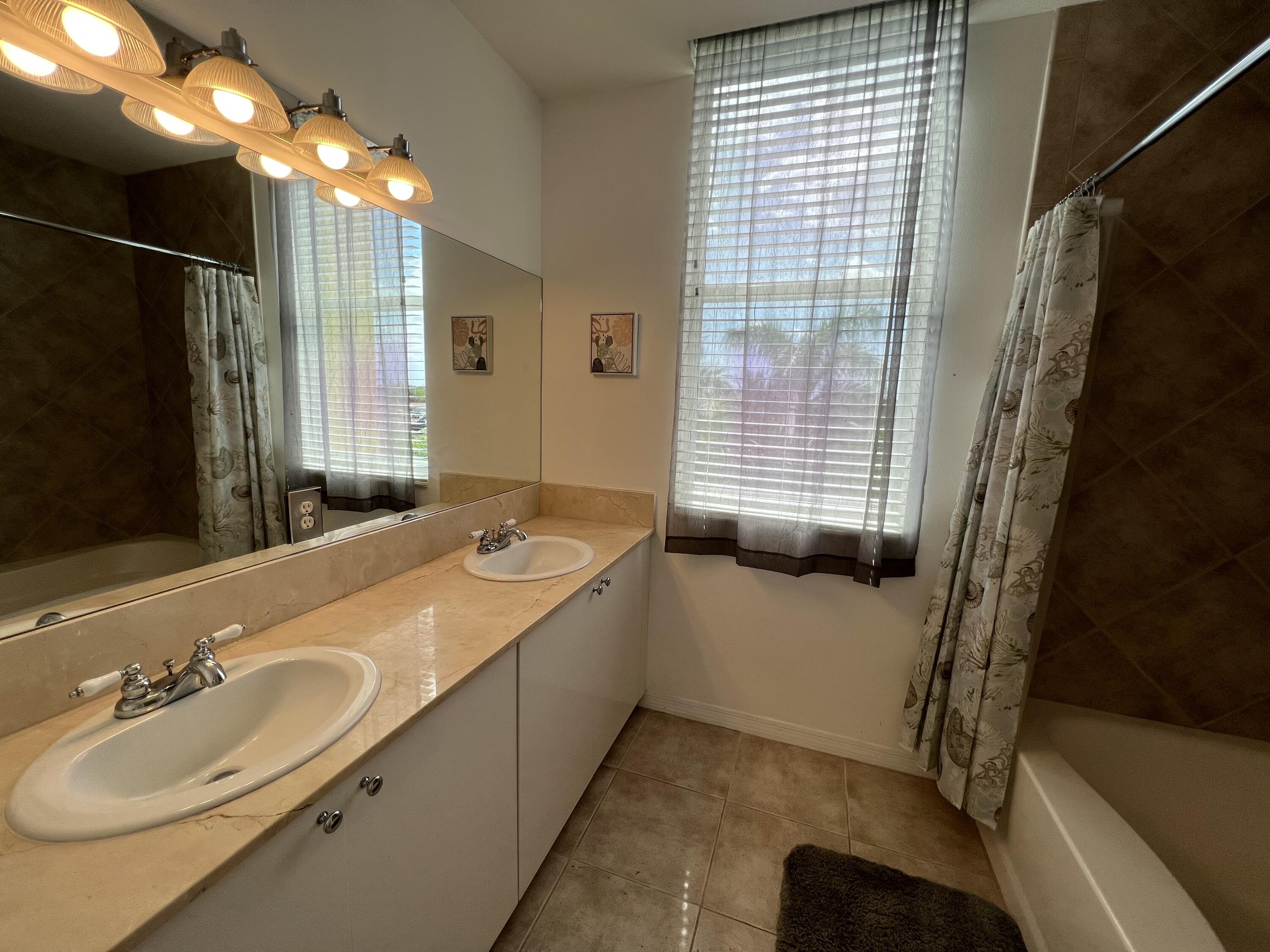 802 West Windward Way, Unit PH15 Lantana, FL 33462 - Photo 30 of 34 a bathroom with a granite countertop sink a toilet and shower