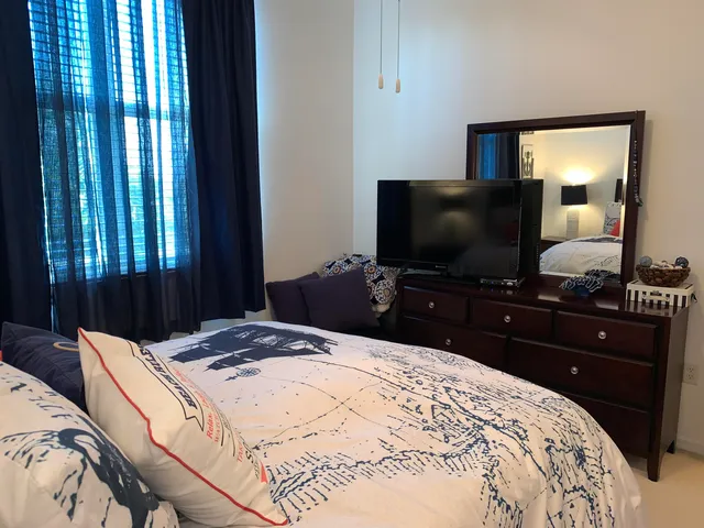 a bedroom with a bed and window