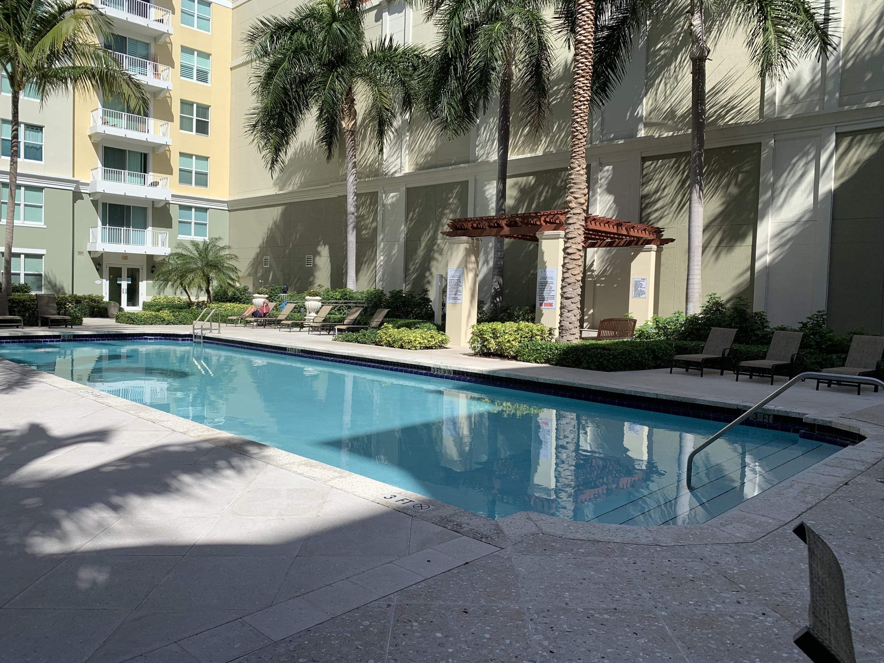 802 West Windward Way, Unit PH15 Lantana, FL 33462 - Photo 10 of 34 a view of house with swimming pool and a yard