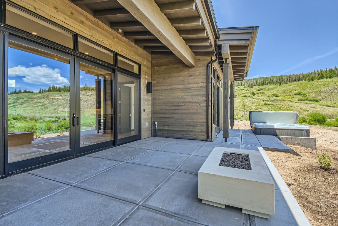 280 Monitor Drive Breckenridge, CO 80424 - Photo 31 of 50 Back patio overlooking the Blue River with fire table and hot tub in recently complete home