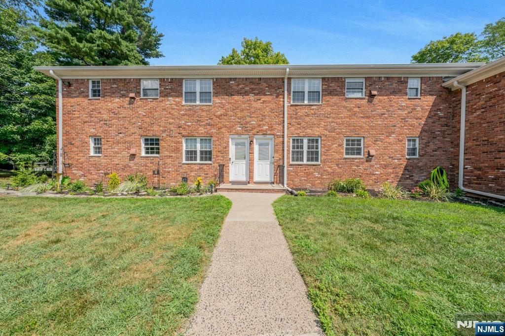 two front view of a house with garden
