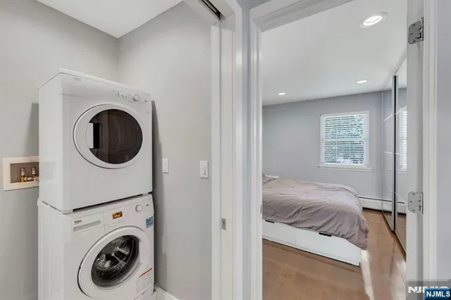a view of a bedroom with washer and dryer