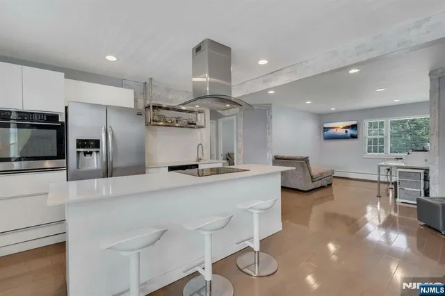 a large kitchen with a large counter top appliances and cabinets
