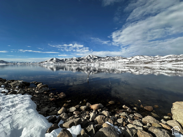 369 East Overlook Loop Kamas, UT 84036 - Photo 51 of 64 Expansive body of water with reflections, bordered by a rocky shoreline and snow-covered terrain