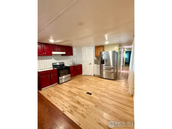 a kitchen with stainless steel appliances kitchen island granite countertop a sink and cabinets