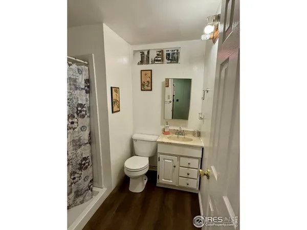 a bathroom with a sink toilet a mirror and shower