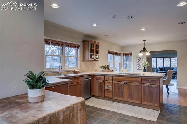 a large kitchen with sink and a window