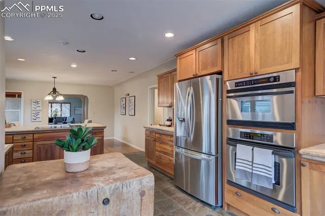 a kitchen with stainless steel appliances a refrigerator and a stove