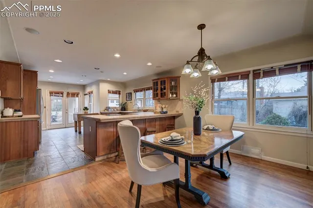 a dining room with furniture window and wooden floor