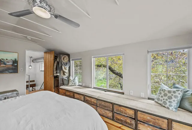 a view of a hallway with wooden floor and windows