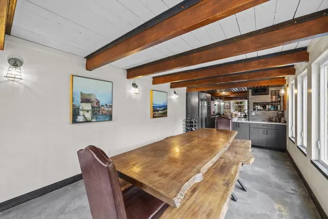 a view of a hallway with wooden floor and a large window