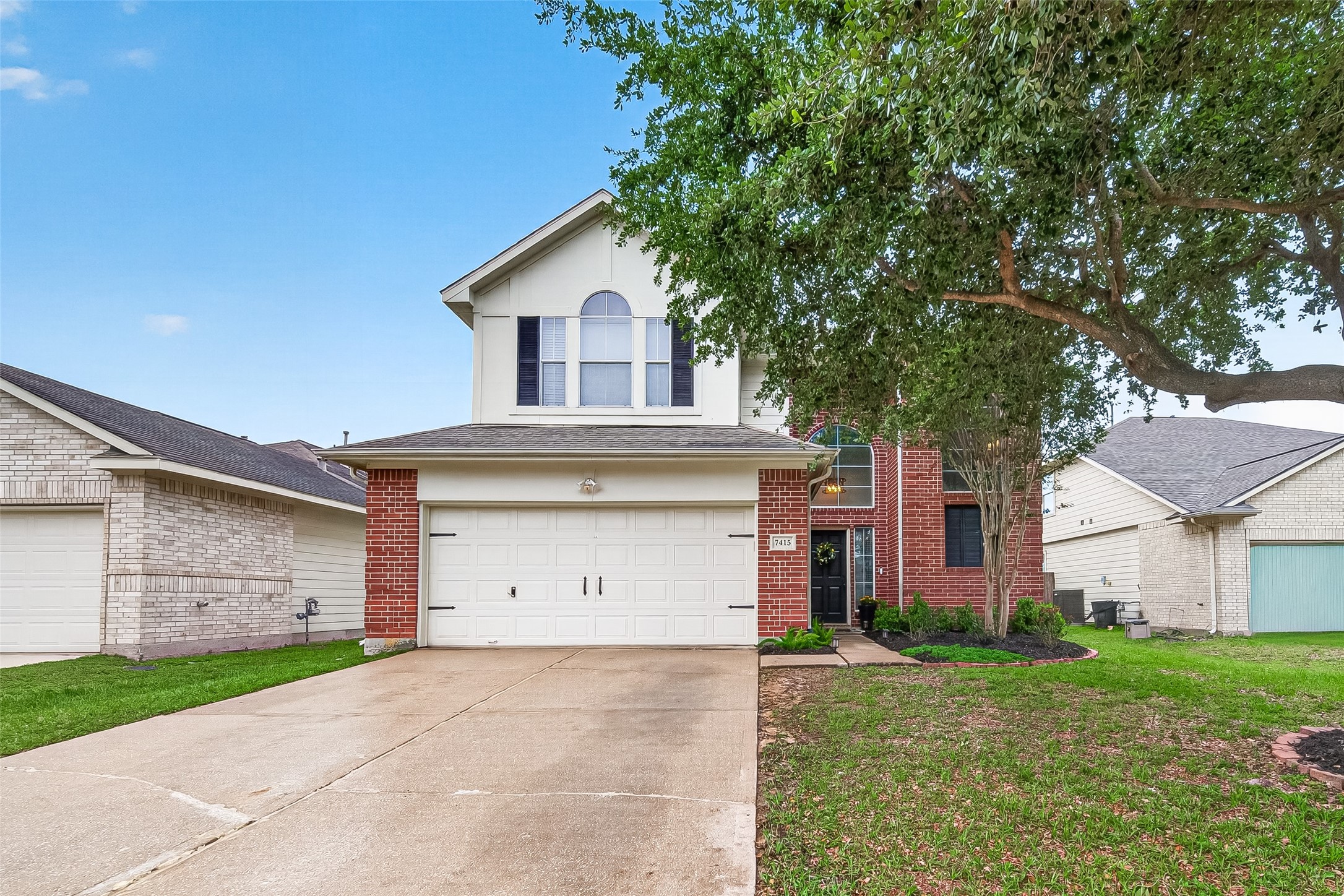 7415 Riven Oaks Court Cypress, TX 77433 - Photo 2 of 42 This beautiful two-story home showcases a timeless brick exterior complemented by mature landscaping and a large shade tree that enhances its curb appeal. The property features a spacious two-car garage with an extended driveway offering ample parking. Nestled in a desirable suburban neighborhood, the home is surrounded by well-kept neighboring residences, creating a welcoming community atmosphere.
