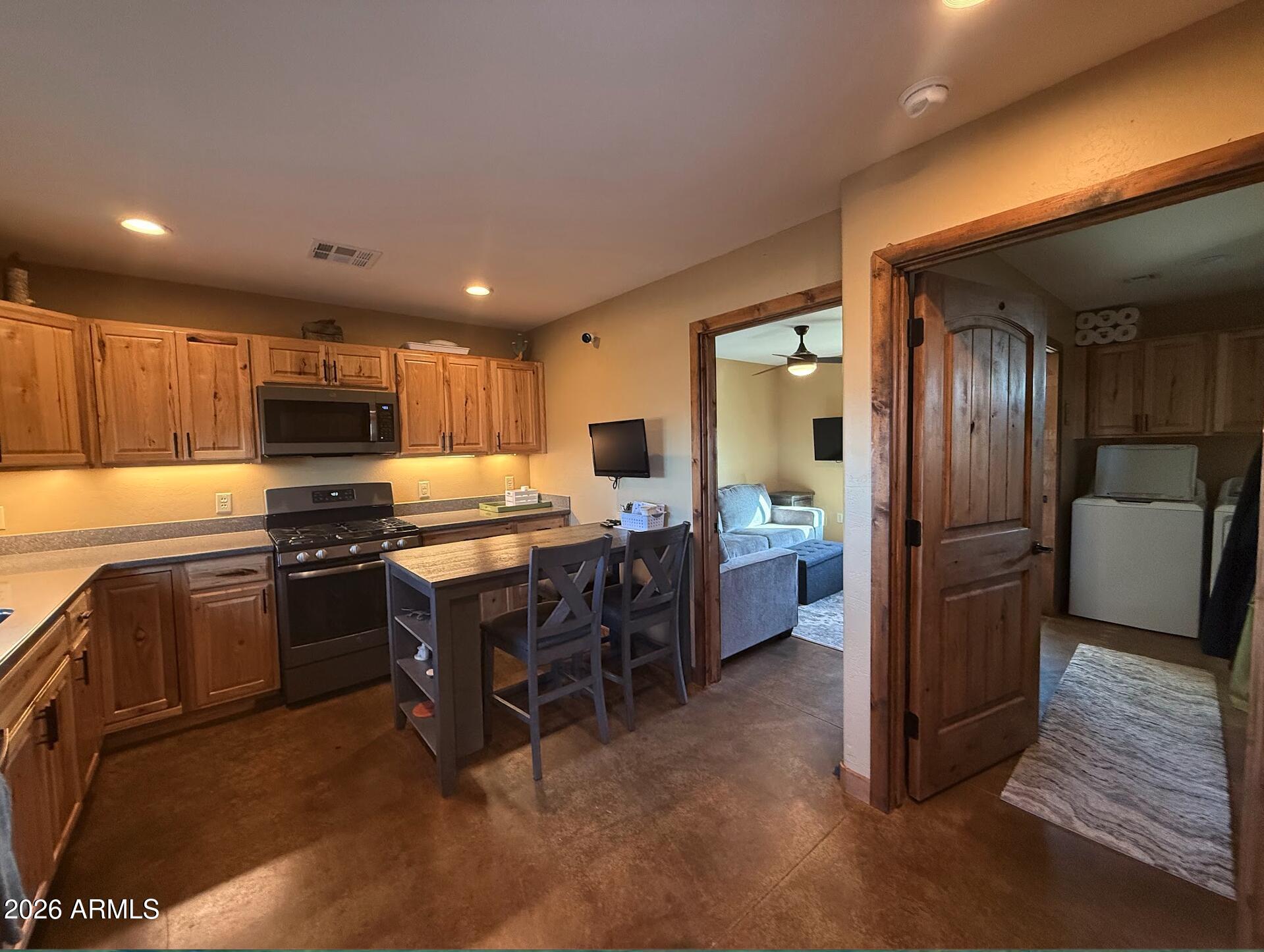 35723 South Amalia Road Eloy, AZ 85131 - Photo 4 of 34 a kitchen with refrigerator a sink and chairs