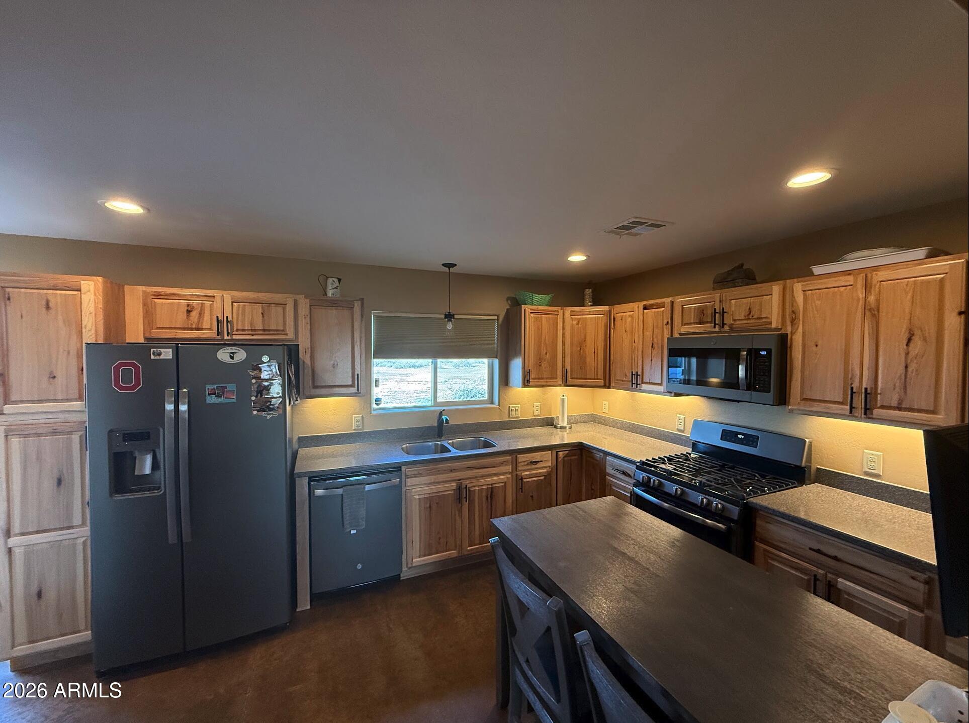35723 South Amalia Road Eloy, AZ 85131 - Photo 5 of 34 a kitchen with stainless steel appliances granite countertop a refrigerator a sink and a stove