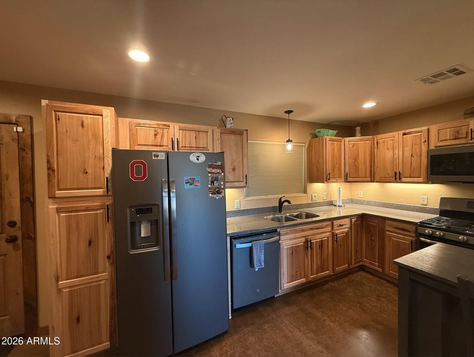 35723 South Amalia Road Eloy, AZ 85131 - Photo 6 of 34 a kitchen with stainless steel appliances granite countertop a refrigerator a sink and wooden cabinets