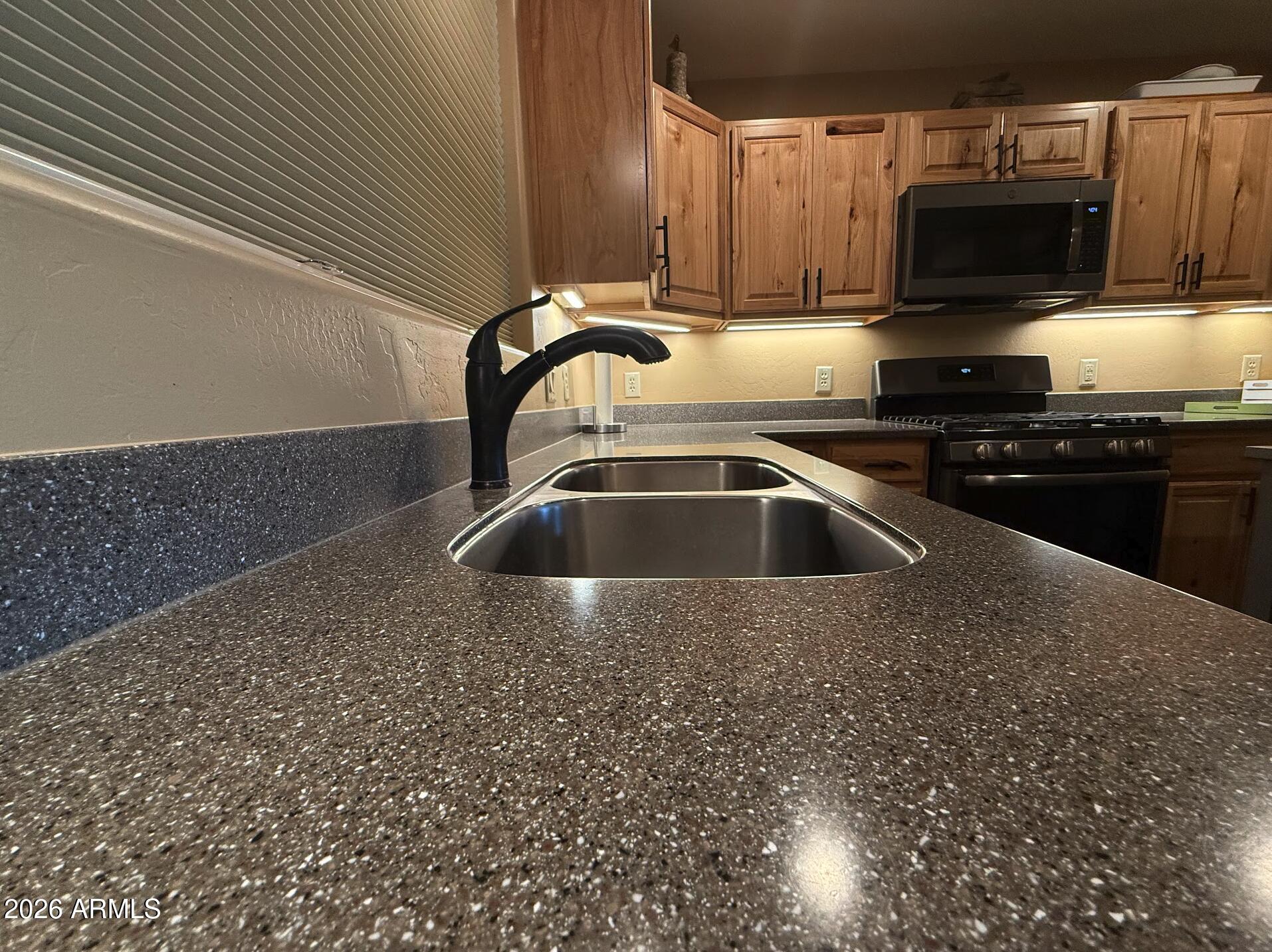 35723 South Amalia Road Eloy, AZ 85131 - Photo 7 of 34 a kitchen with a sink and a stove top oven