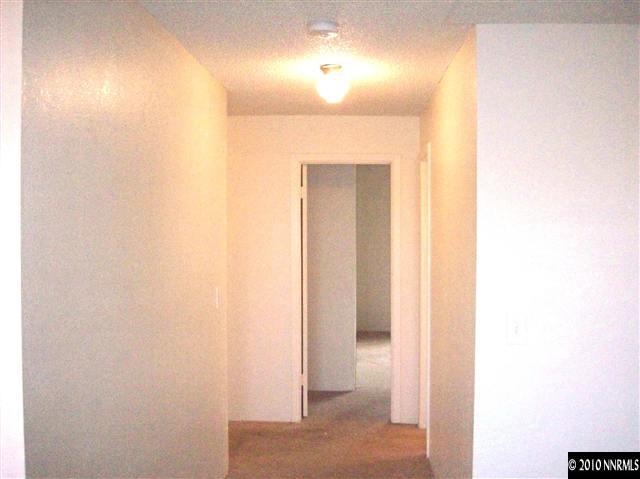 3880 East Leonesio Drive, Unit C2 Reno, NV 89512 - Photo 5 of 7 a view of a hallway with wooden floor