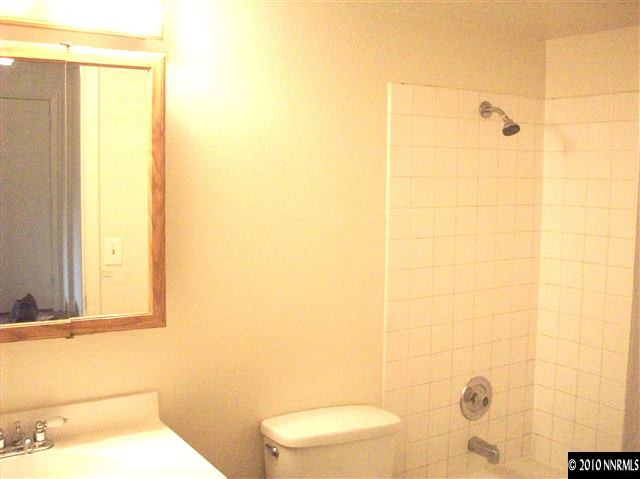 3880 East Leonesio Drive, Unit C2 Reno, NV 89512 - Photo 6 of 7 a bathroom with a toilet and a shower