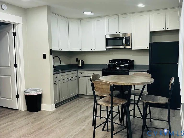 350 Staten Street Norfolk, VA 23503 - Photo 5 of 12 a kitchen with stainless steel appliances a stove a sink and a refrigerator