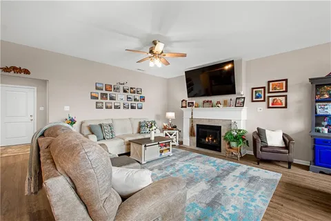 a living room with furniture a flat screen tv and a fireplace