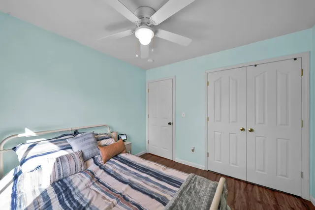 a bed room with a bed and a ceiling fan