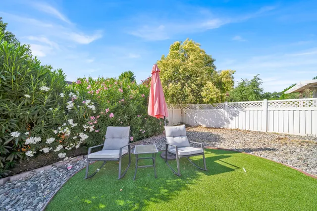 a view of a chair and table in the garden