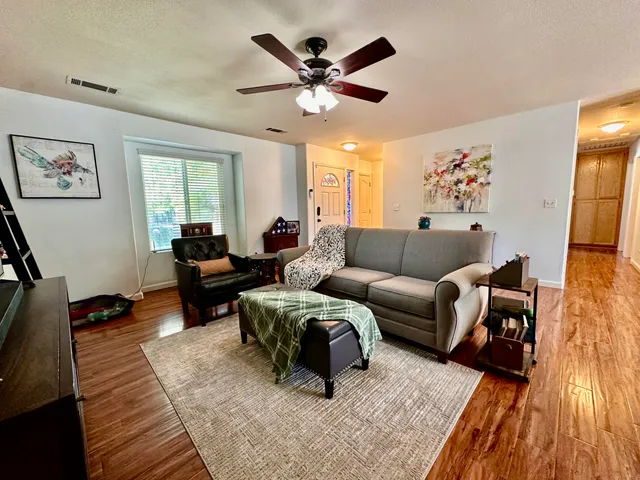 a living room with furniture rug and window