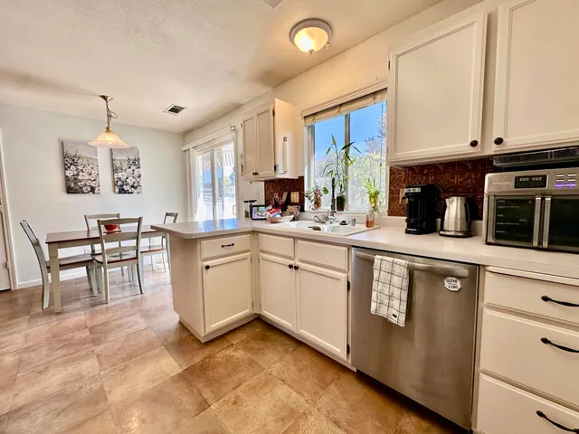 a kitchen with a sink stove and cabinets