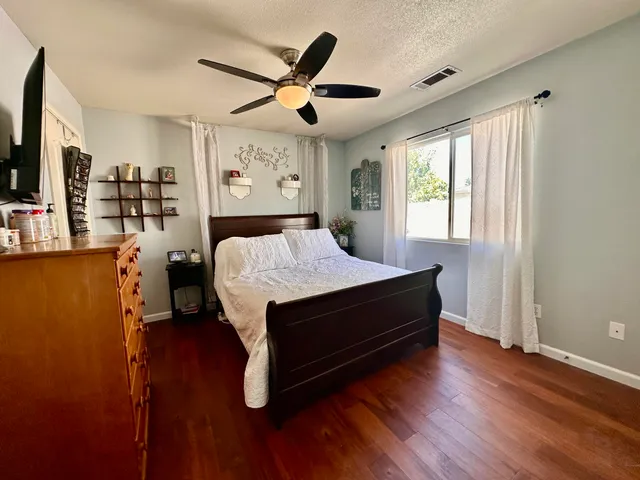 a bedroom with a bed and a large window