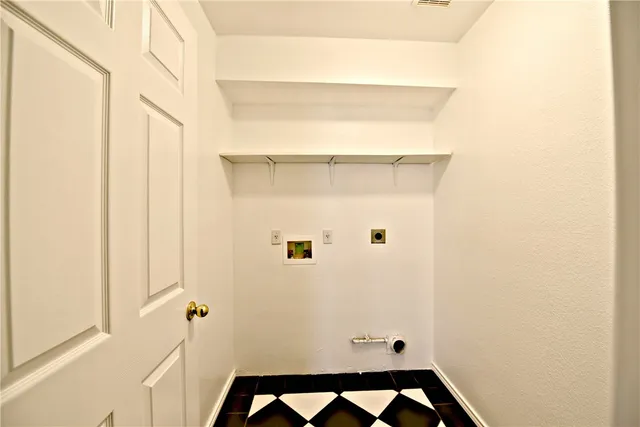 an empty room with wooden floor ceiling fan and windows