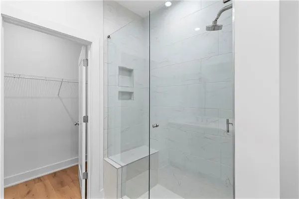 a bathroom with a glass shower door