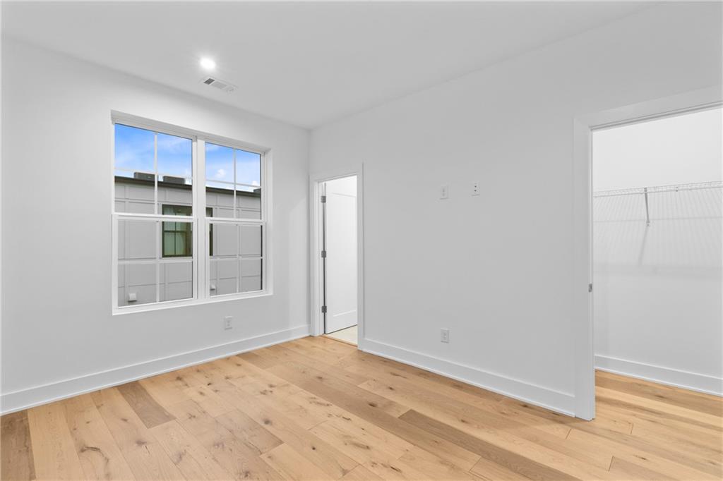 201 New Street, Unit 1204 Decatur, GA 30030 - Photo 21 of 26 an empty room with cabinet and windows
