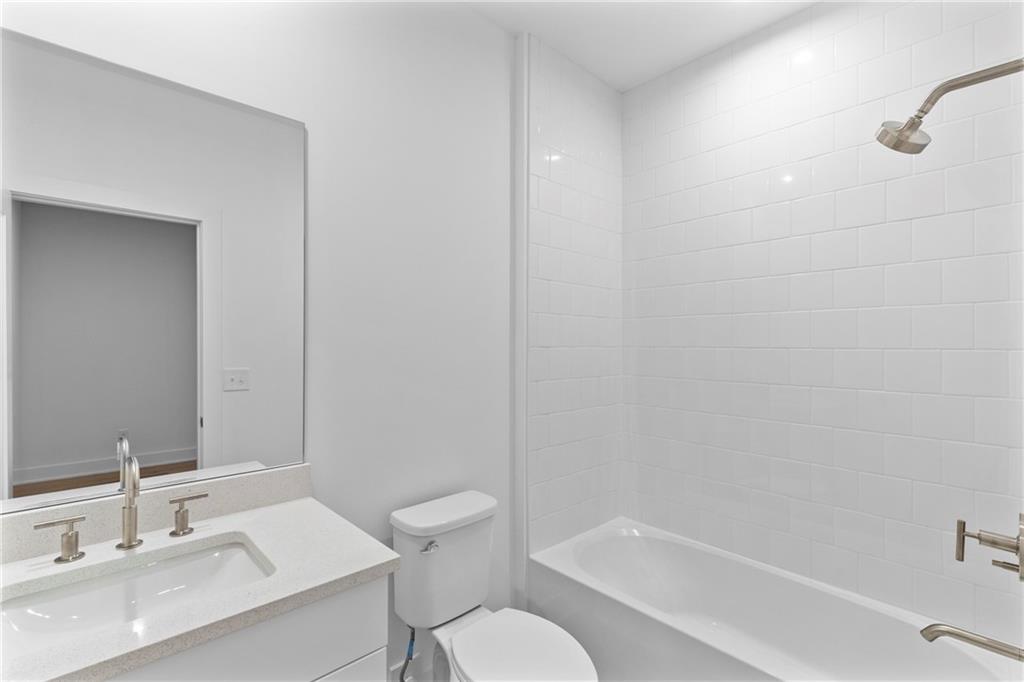 201 New Street, Unit 1204 Decatur, GA 30030 - Photo 23 of 26 a bathroom with a sink toilet and shower