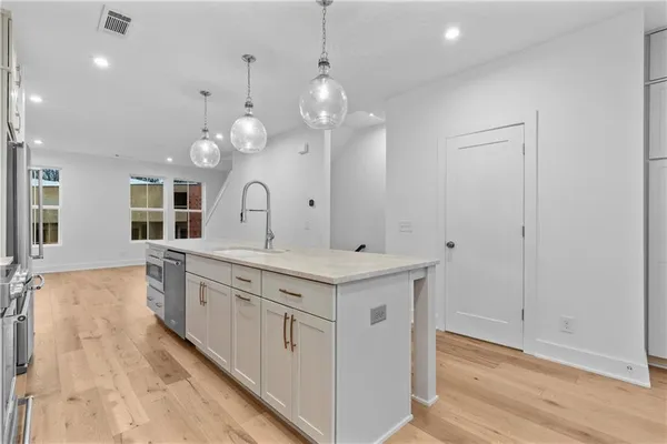 a bathroom with a sink a vanity a mirror and a shower