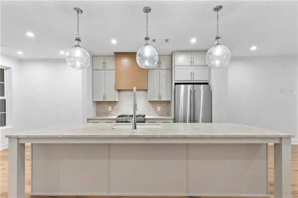 a view of a kitchen with a sink and chandelier